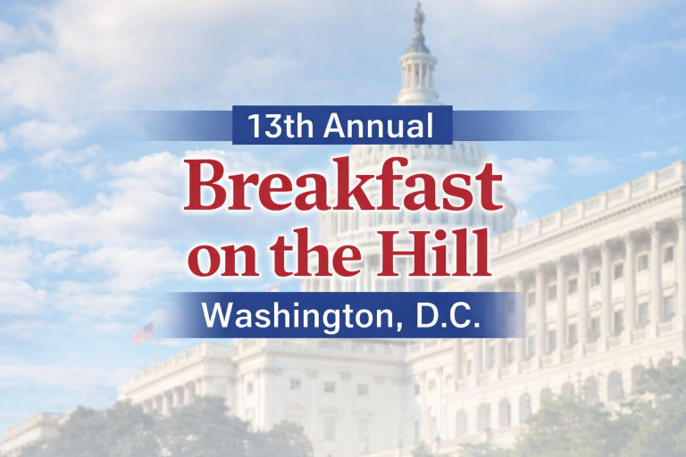 Text reading "13th Annual Breakfast on the Hill, Washington, D.C." is overlaid on a blurred image of the U.S. Capitol building against a partly cloudy sky.